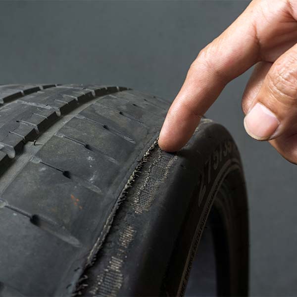 Mechanic inspecting tire