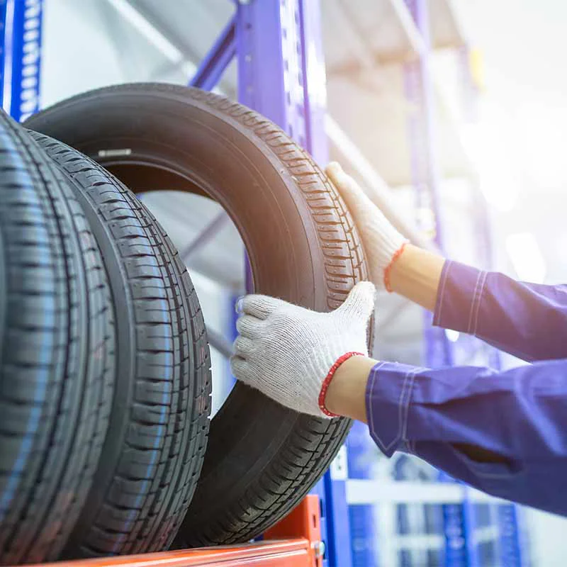 tires-2 Mechanic holding black car tire
