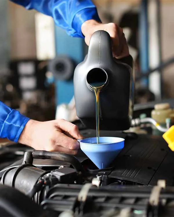 tune-up-1 Car mechanic filling oil
