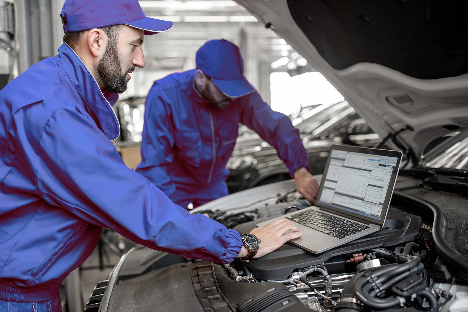 image of car mechanic diagnosing with laptop
